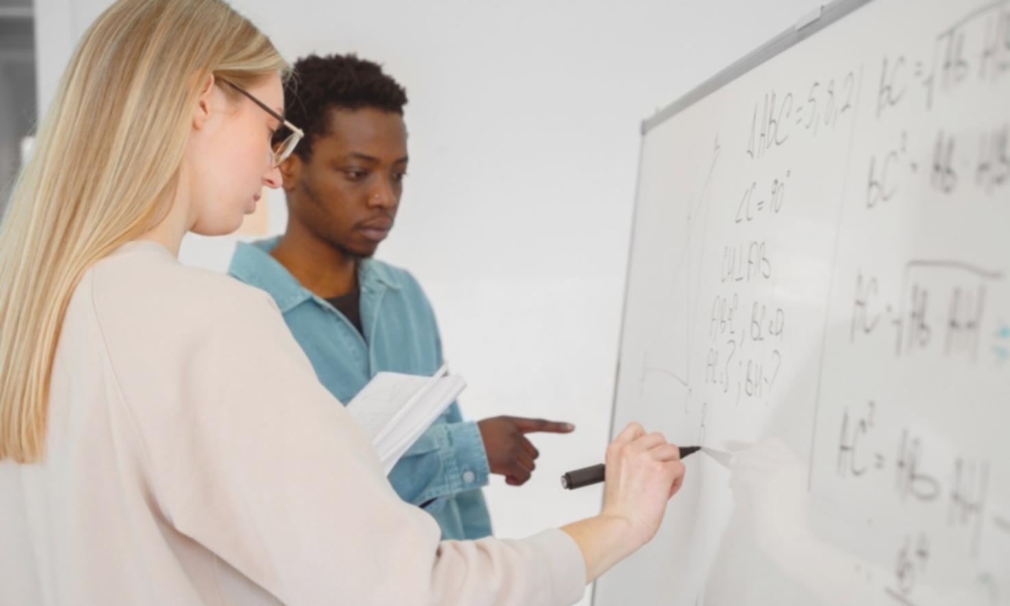 Professional financial consultant reviewing documents with client in modern office setting